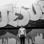 Man looking up at Jesus sign