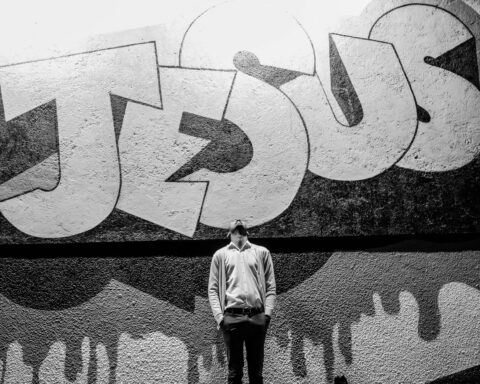 Man looking up at Jesus sign