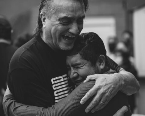 People hugging after water baptism