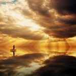 Fisherman in dawn sky