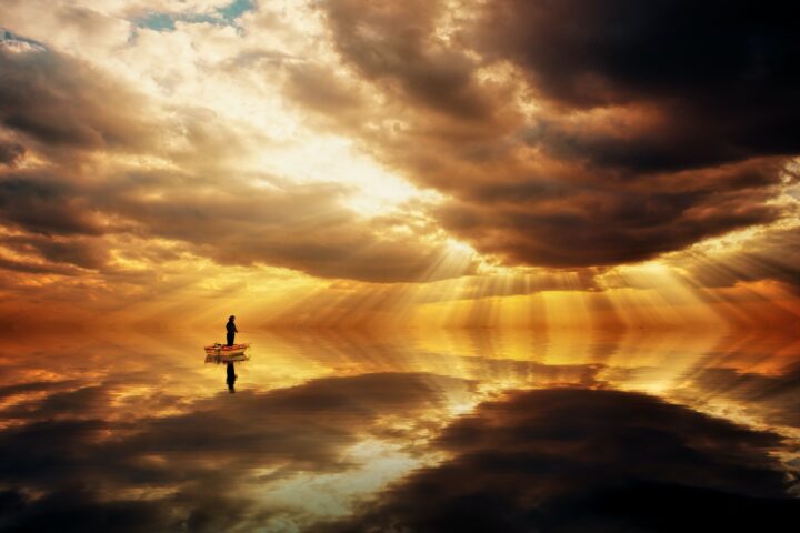 Fisherman in dawn sky
