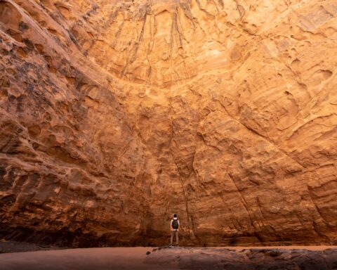 Wall of rock towering over man