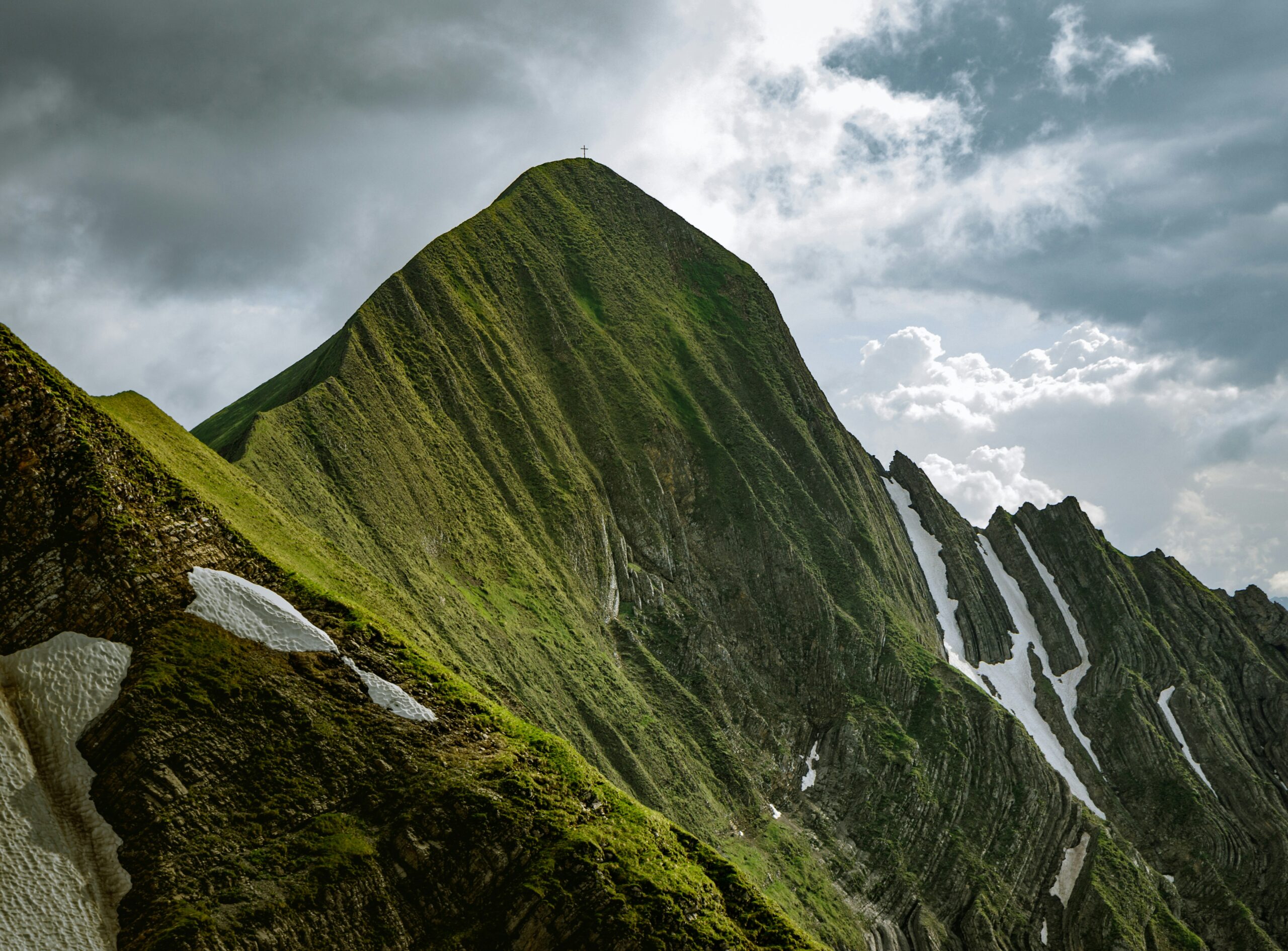 Green hilltops with snow