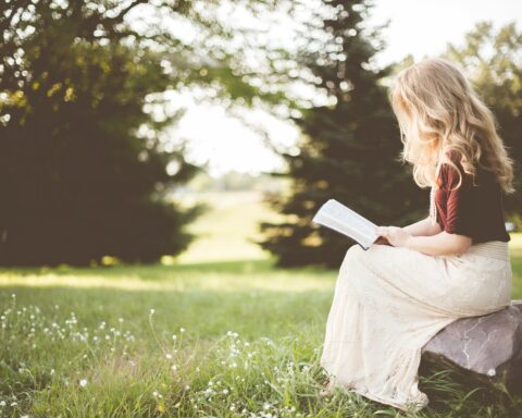 Girl reading BIble in garden