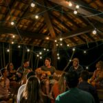 An intimate musical gathering under string lights in São Paulo, Brazil.