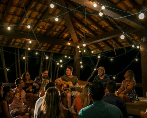 An intimate musical gathering under string lights in São Paulo, Brazil.