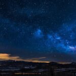 A breathtaking view of the Milky Way galaxy illuminating the night sky over mountains.